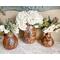 These are three finished gourd vases with faux flower arrangements. The artwork includes a sunflower and butterfly artwork on the front.